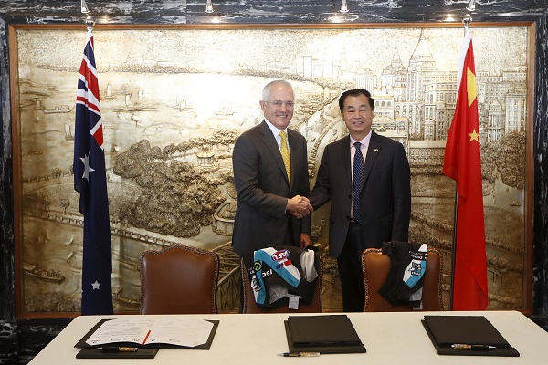 Australian Prime Minister Malcolm Turnbull shake hands with Gui Guojie, general manager of Shanghai CRED Real Estate Stock after a signing of the memorandum of understanding at a hotel in Shanghai