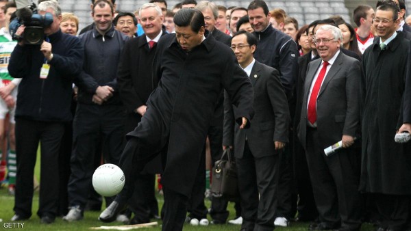 Chinese Vice-President Xi Jinping (C) kicks a Gaelic football as he visits the Croke Park in Dublin on February 19, 2012 to attend an exhibition of Gaelic football and hurling. Xi Jinping, China's leader-in-waiting, arrived on February 18 for a three-day visit to Ireland, nine years after he first visited the country. Xi will hold talks with Prime Minister Enda Kenny and attend an Ireland-China trade forum in Dublin involving about 300 companies. AFP PHOTO/ PETER MUHLY (Photo credit should read PETER MUHLY/AFP/Getty Images)