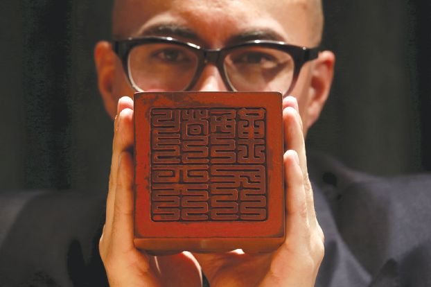 File photo of a seal carved for the Kangxi Emperor, is displayed by Sotheby's Asia Deputy Chairman Nicholas Chow at a preview in Hong Kong